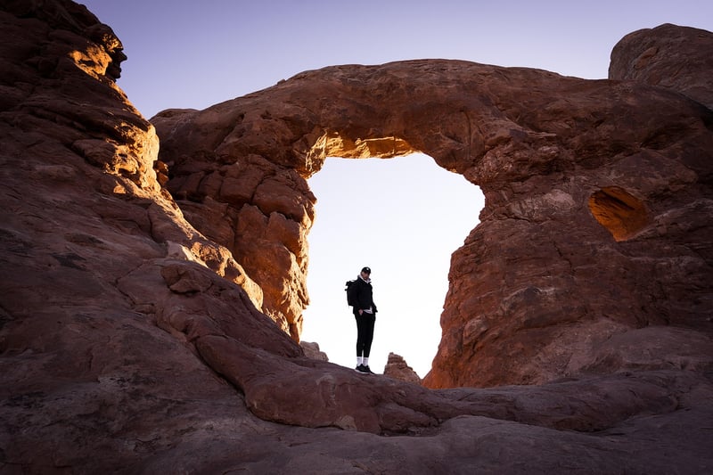 Hiker reaching mountain top